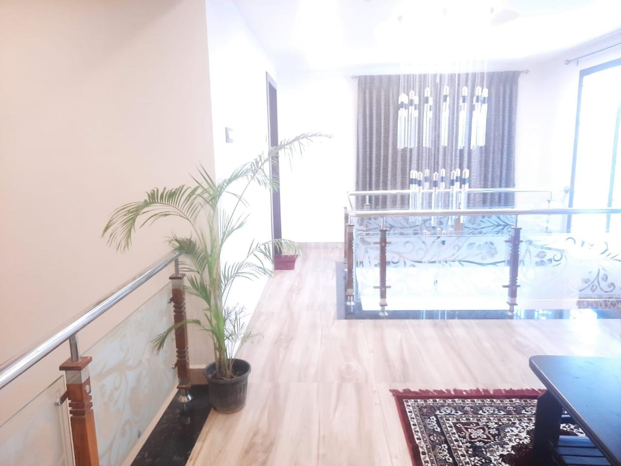 Upper floor lobby chandelier and glass railing