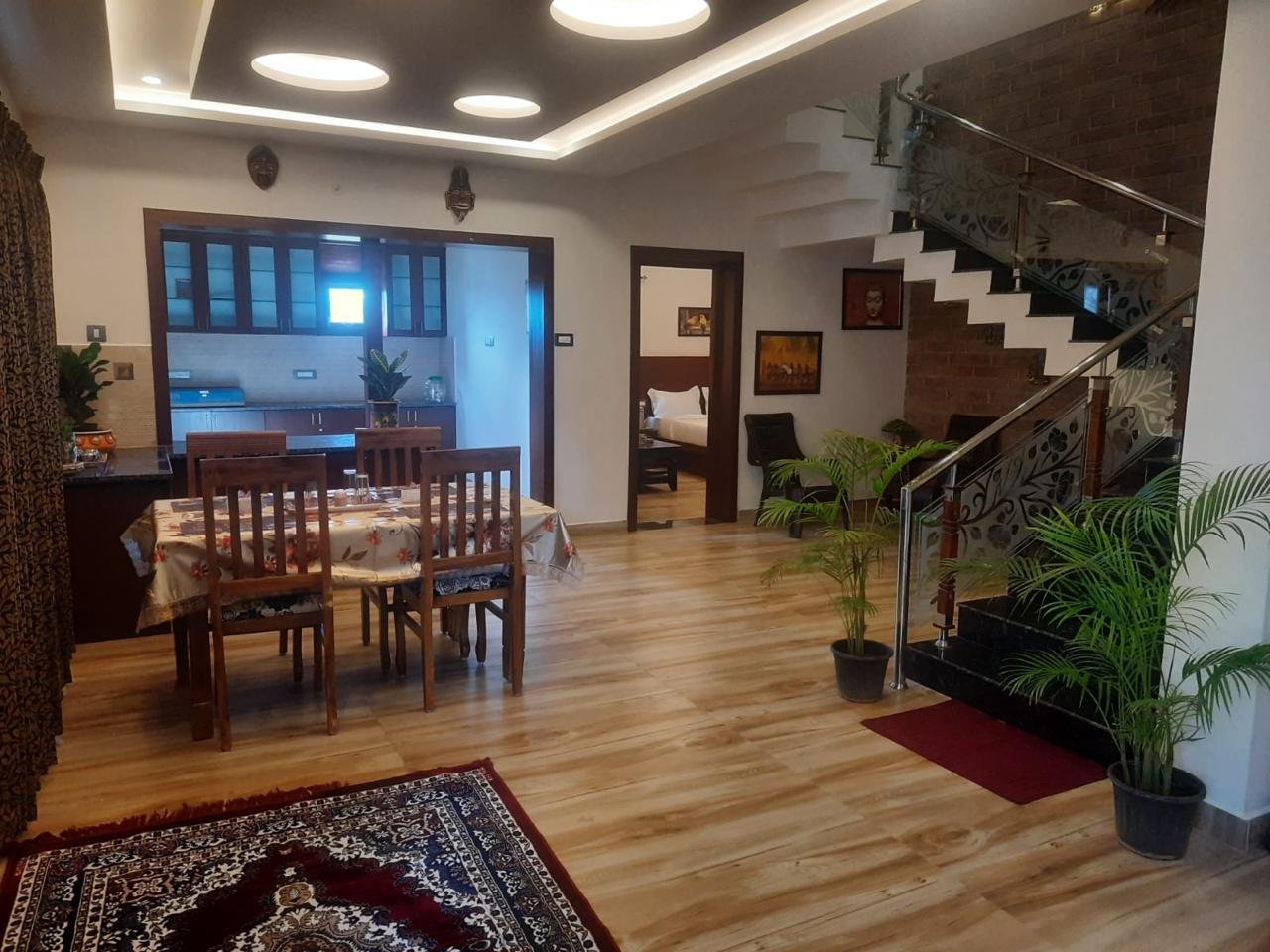 Dining area and grand staircase at Kodai Vellapar Homestay