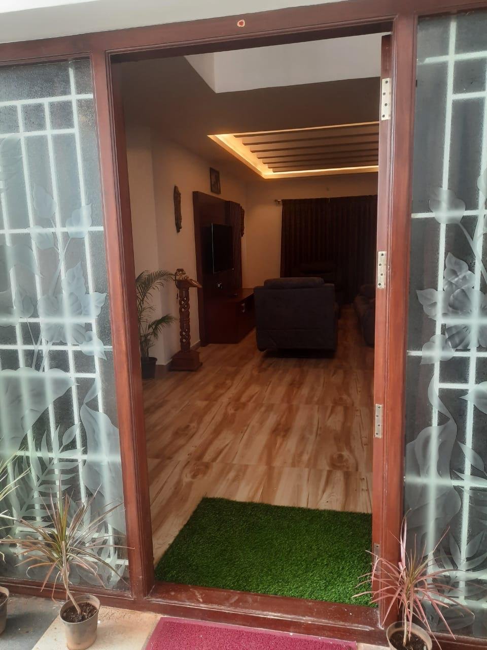 Grand wooden entrance doorway leading to living hall