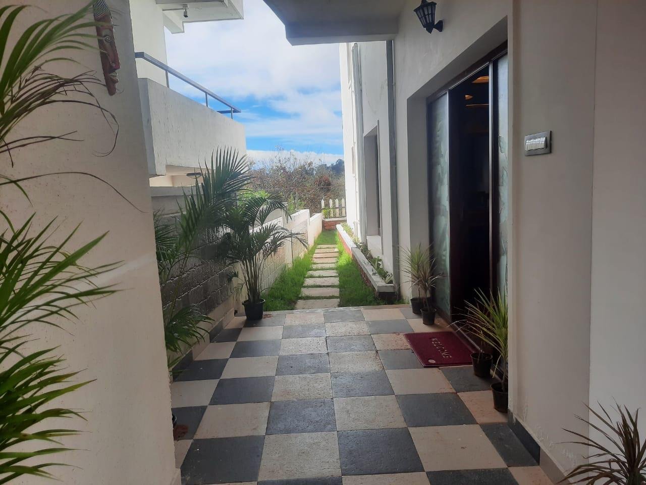 Private stone garden pathway and lush green lawn